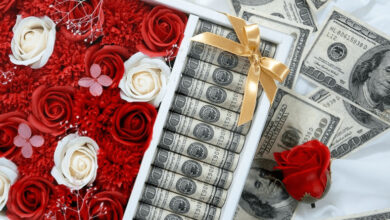 صورة باقة ورد حمراء مع نقود دولارات كثيرة في بوكس هدايا